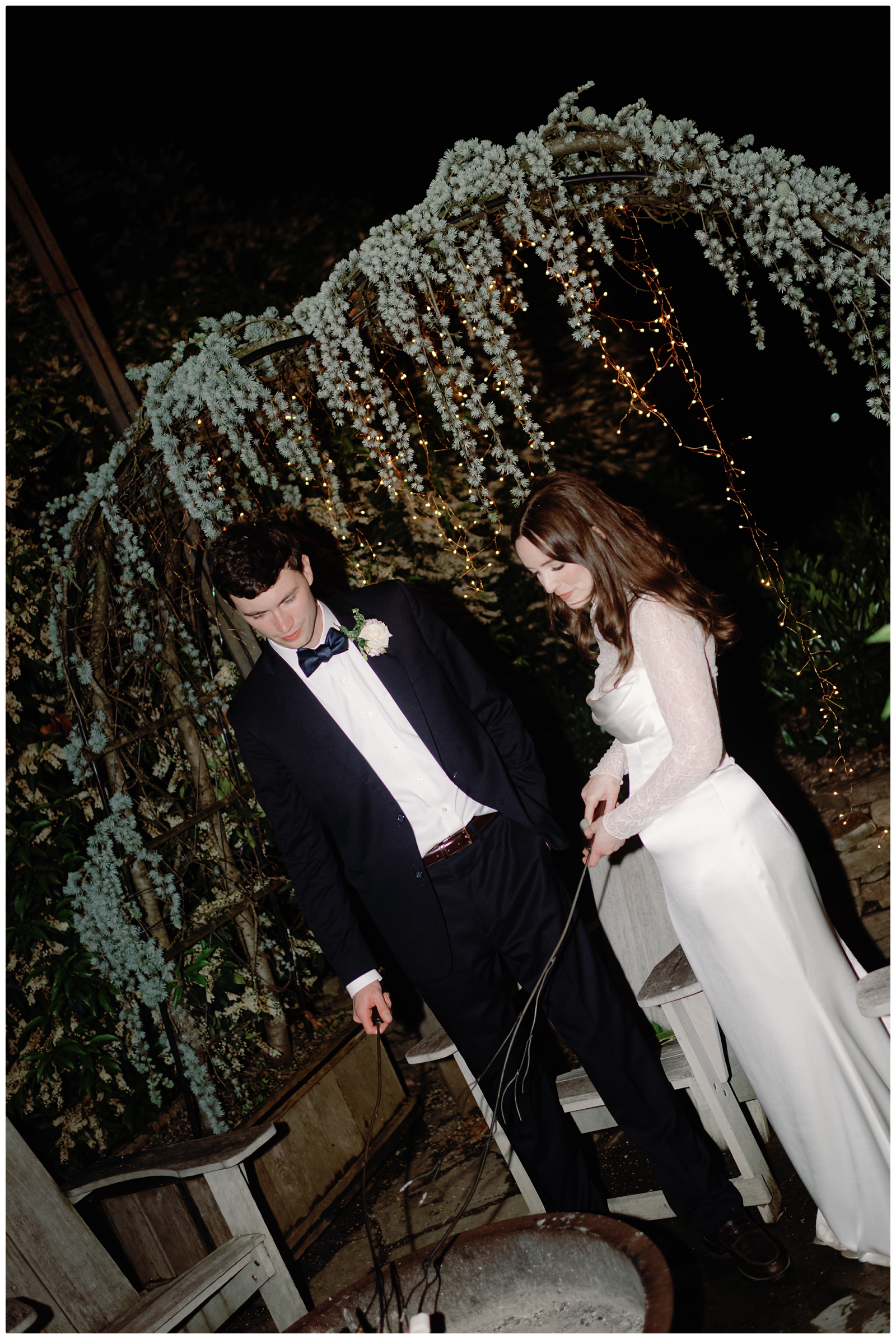 bride and groom making smores at their Terrain at Styers wedding